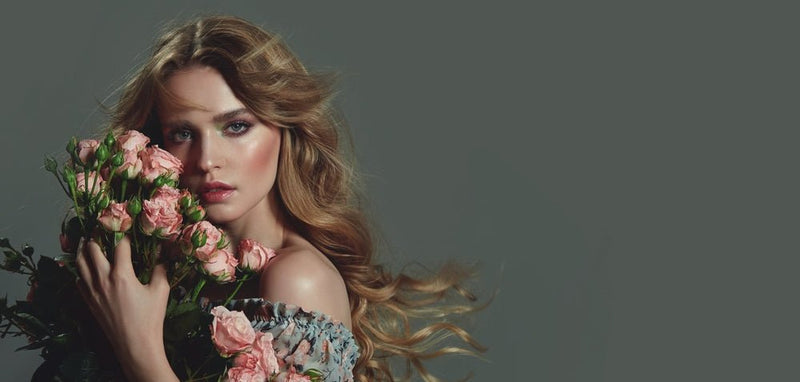 lady long red hair holding flowers